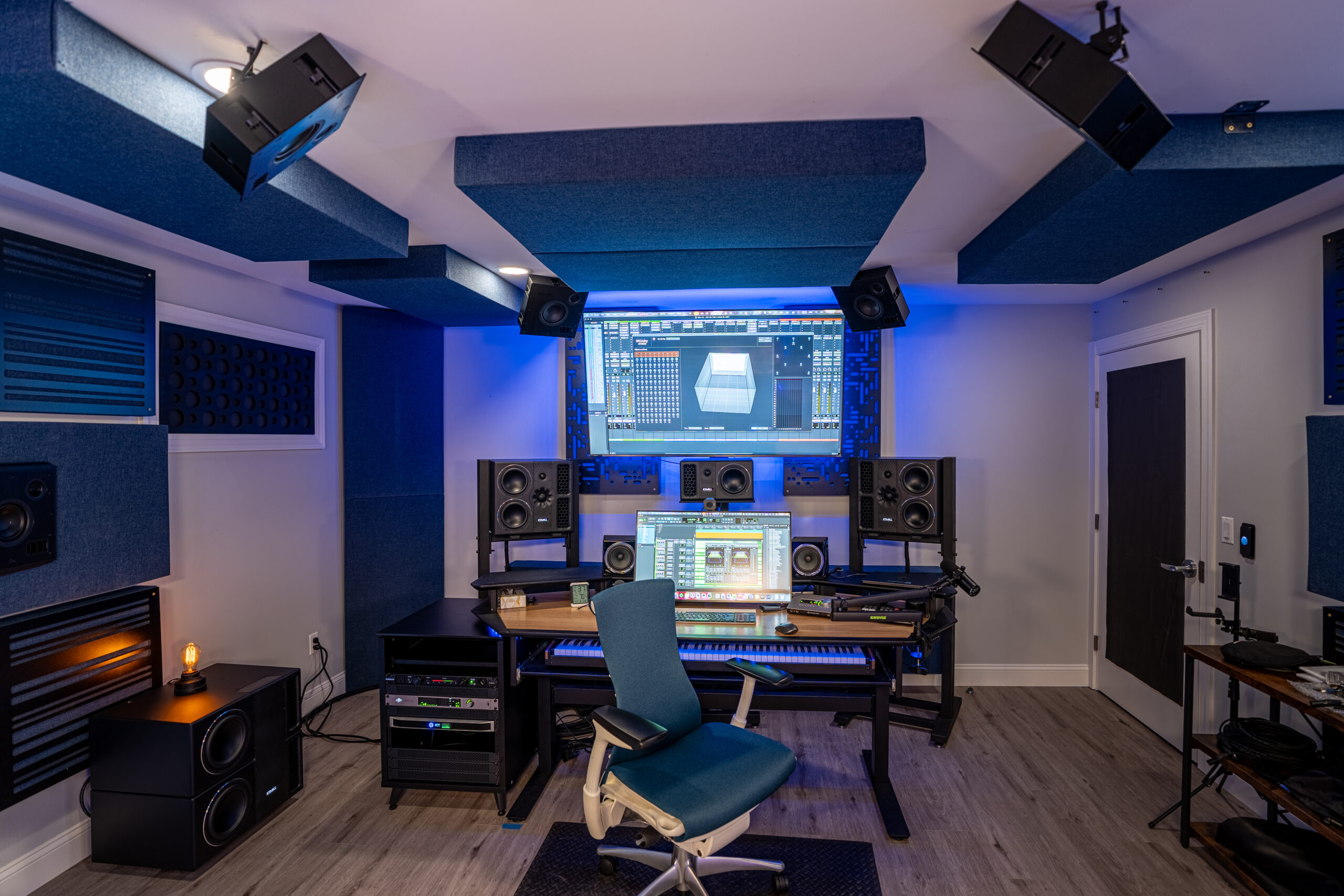 IndigoCorvid Atmos Studio viewed from the back of the room showing PMC monitor system and producer chair